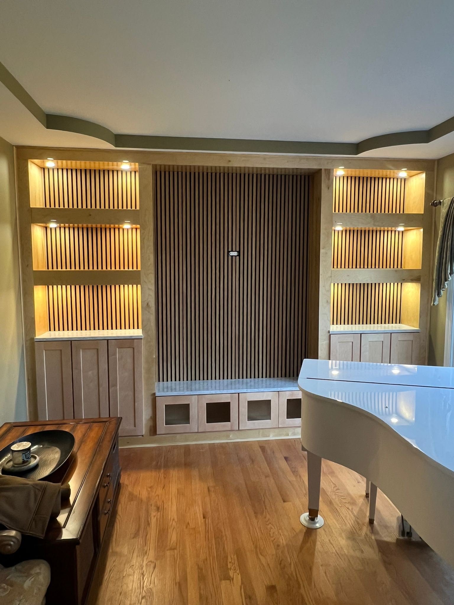 Custom living room cabinetry and wood feature wall