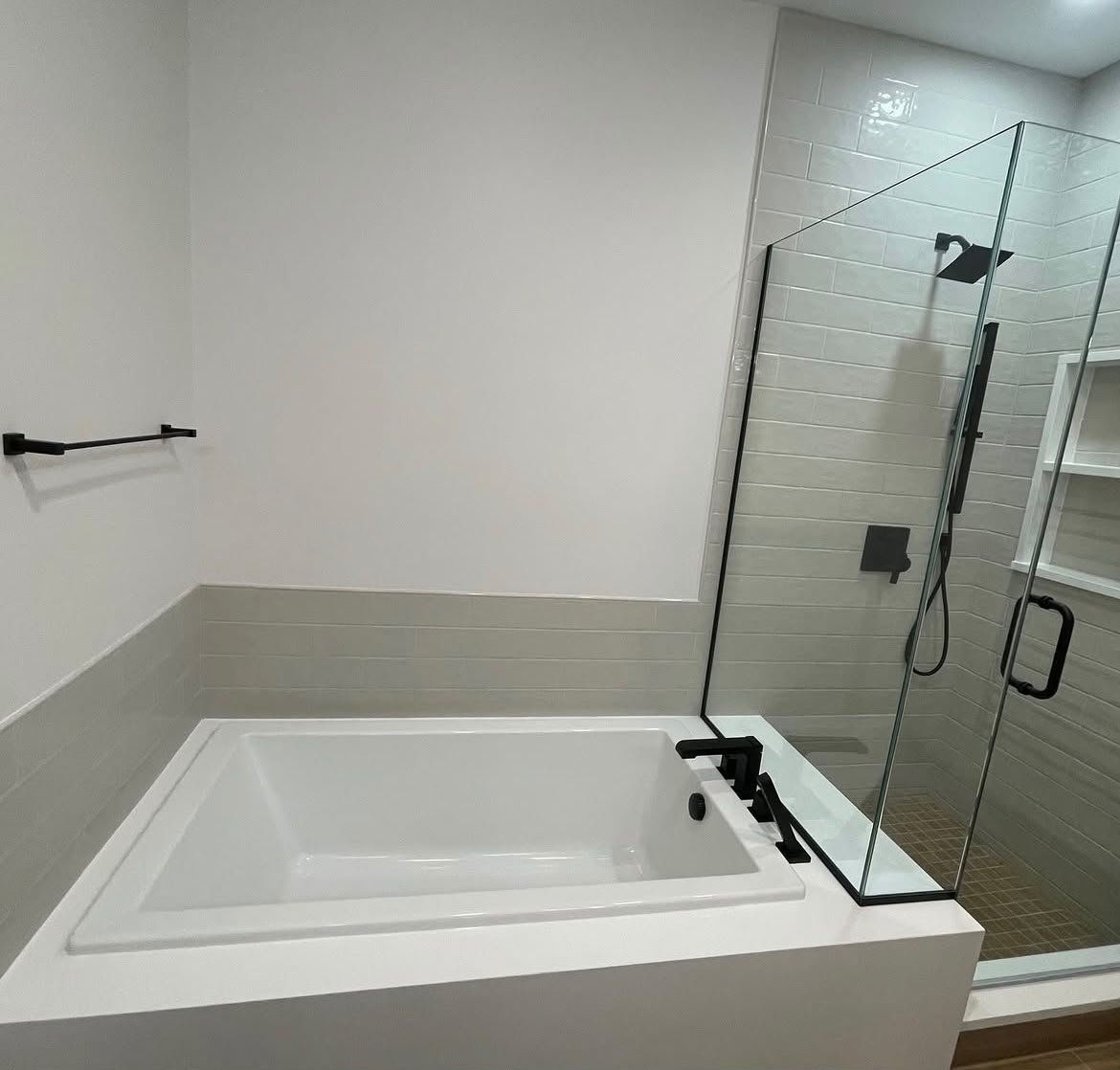 Finished bathroom with soaking tub and glass shower